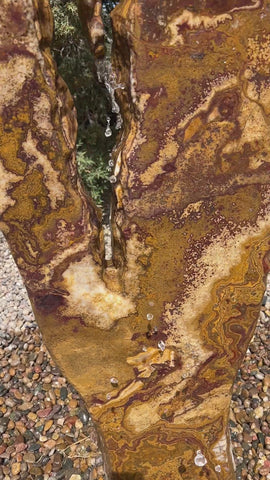 Grand Canyon Red Onyx stone fountain in a landscape setting handcrafted by The Rock Star Gallery®