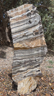 Vertical banded Black Canyon Onyx stone fountain by The Rock Star Gallery in courtyard patio landscape design.
