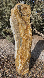Caramel Canyon Onyx stone fountain made by The Rock Star Gallery in garden setting