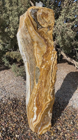 Caramel Canyon Onyx stone fountain made by The Rock Star Gallery in garden setting