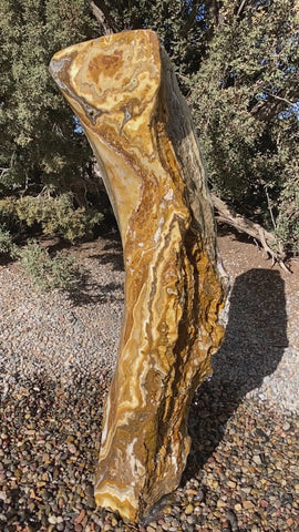 Caramel Canyon Onyx stone fountain made by The Rock Star Gallery in garden setting