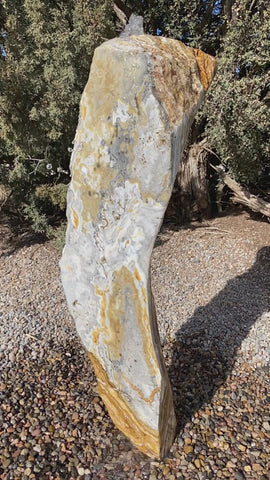 Caramel Canyon Onyx stone fountain made by The Rock Star Gallery in garden setting