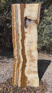 Grand Canyon Red Onyx stone fountain in a landscape setting handcrafted by The Rock Star Gallery®