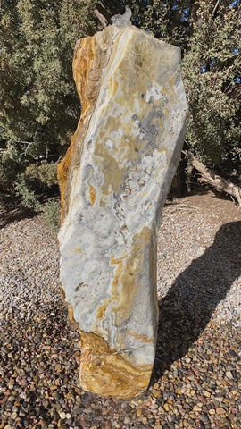 Caramel Canyon Onyx stone fountain made by The Rock Star Gallery in garden setting