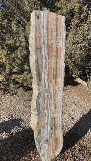 Vertical banded Black Canyon Onyx stone fountain by The Rock Star Gallery in courtyard patio landscape design.