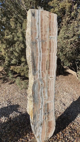 Vertical banded Black Canyon Onyx stone fountain by The Rock Star Gallery in courtyard patio landscape design.