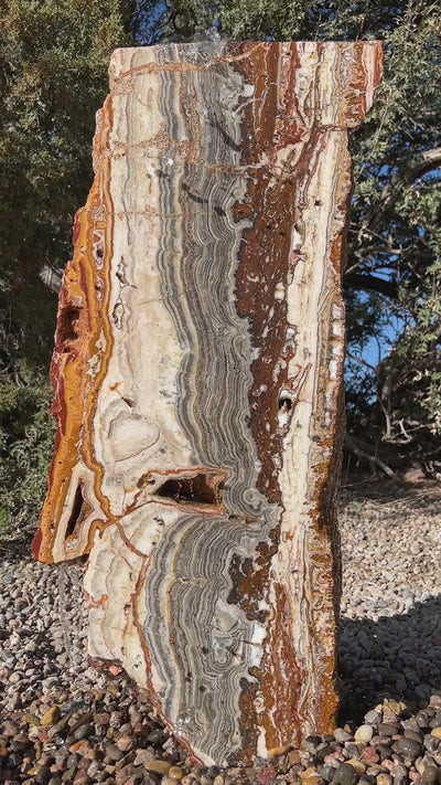 Black Canyon Onyx Fountain with Crazy Lace patterning in a landscape setting