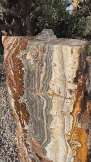 Black Canyon Onyx Fountain with Crazy Lace patterning in a landscape setting