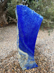Blue Lapis Lazuli stone fountain by The Rock Star Gallery in outdoor landscape setting.