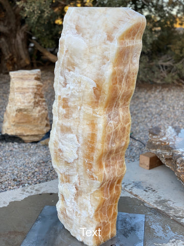 Sunrise Onyx stone fountain by The Rock Star Gallery in a landscape setting.